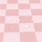 Close-up of water droplets on a Bumkins Wet Bag Plus 2 Pack: Mauve + Sand Check.