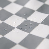 Close-up of water droplets on Bumkins Packing Cube 2 Pack: Charcoal Check.