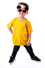 A child in a yellow shirt, dark jeans, and Sunstaches Lil Characters Mickey Mouse Sunglasses smiles confidently on a white background.