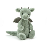 Jellycats Bashful Dragon Medium sits upright with small horns, dark wings, a long tail, and supersoft fur that meets European Safety Standard.