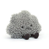 The Jellycat Amuseable Storm Cloud: a plush gray cloud with a sad face and brown legs, adorably seated on white.