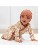 Romper, Wild West Brown by Tesa Babe: baby in a brown patterned onesie and matching beanie, crawling on soft hypoallergenic fabric.
