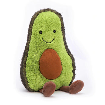 The Jellycat Amuseables Avocado Large is a plush with a smile, brown pit, and feet on a white backdrop.
