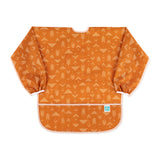 Bumkins Long-Sleeved Art Smock: Grounded features orange waterproof fabric with a white arrow pattern and an adjustable tie neck closure.