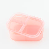 Bumkins Silicone Bento Box 3 Section: Pink Jelly, with lid askew, sits on a white background.