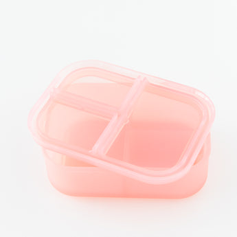 Bumkins Silicone Bento Box 3 Section: Pink Jelly, with lid askew, sits on a white background.