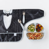 Bumkins Sleeved Bib: Jack Skellington lays flat on a white background next to a divided plate filled with food and matching utensils.