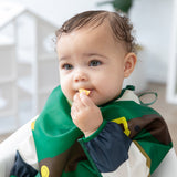 A child eats a snack while wearing a bib from Bumkins Snack In Character 4-Piece Set: Nintendo Zelda.