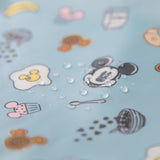 Close-up of water droplets on Bumkins Sleeved Bib: Mickey + Minnie Sunny Side Up.