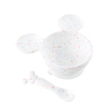 Bumkins Silicone First Feeding Set: Mickey Mouse Vanilla Sprinkle includes a confetti Mickey Mouse-shaped silicone bowl and matching spoon.