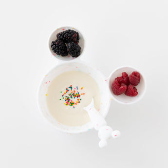 Bumkins Silicone First Feeding Set: Mickey Mouse Vanilla Sprinkle with yogurt with sprinkles and berries on a white background.