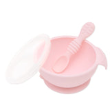Bumkins Silicone First Feeding Set: Pink includes a bowl with suction bottom, a matching spoon, and a transparent lid.