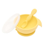 Bumkins Silicone First Feeding Set: Pineapple includes a bowl with suction bottom, a matching spoon, and a transparent lid.
