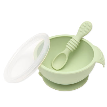 Bumkins Silicone First Feeding Set: Sage includes a bowl with suction bottom, a matching spoon, and a transparent lid.