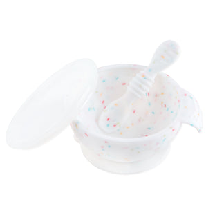 Bumkins Silicone First Feeding Set: Vanilla Sprinkle includes a white speckled bowl with secure suction base, matching spoon, and clear lid.