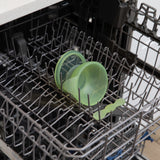 Bumkins Silicone First Feeding Set: Green Jelly sits in the top rack of an open dishwasher.