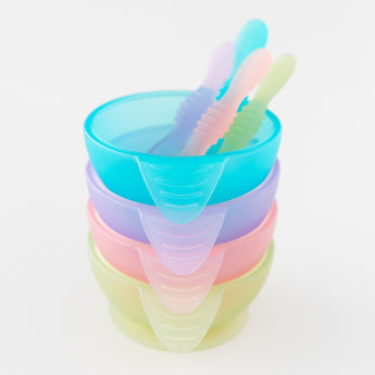 A stack of four colorful bowls with spoons, on a white background, with Bumkins Silicone First Feeding Set: Green Jelly on the bottom.
