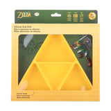 Bumkins Silicone Grip Dish: Zelda™ Triforce is shown in a green and yellow packaging box, with a clear front window displaying the dish.