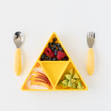 Bumkins Silicone Grip Dish: Zelda™ Triforce holds berries, peaches, and avocado next to yellow handle utensils on a white background.