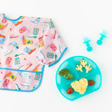 Bumkins Grip Dish Deluxe Infant 5-Piece Mealtime Set: Blue Jelly holds veggies & snacks next to a boot-patterned bib on a white background.