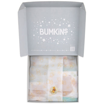 An open gift box containing Bumkins Disney Little Ones Gift Bundle, Winnie The Pooh wrapped in patterned tissue paper.