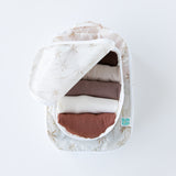 A top down view of Bumkins Packing Cube 2 Pack: Palm Daze stacked on a white background. The top cube is open and holds folded clothes.