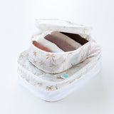 Bumkins Packing Cube 2 Pack: Palm Daze sit stacked on a white background. The top cube is open, holding folded clothes.