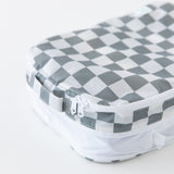 Close-up of a Bumkins Packing Cube 2 Pack: Charcoal Check on a white background, highlighting the top handle and zipper.