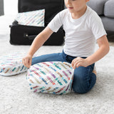 A child zips a Bumkins Disney Mickey & Friends Packing Cube from the 2 Pack Set by an open suitcase on the carpet.