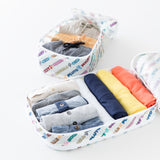 Bumkins Packing Cube 2 Pack: Mickey & Friends Varsity sit open on a white background, filled with rolled clothes.