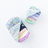 Bumkins Packing Cube 2 Pack: Aloha Stitch is filled with pastel clothes on a white background.