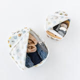 Open Bumkins Packing Cube 2 Pack: Winnie + Friends, filled with neatly packed clothes, shoes, and socks, are displayed on a white background.