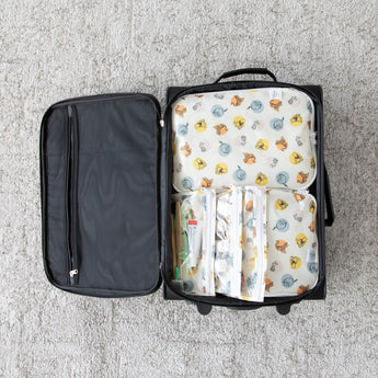 Bumkins The Outfit Organizer Essential 5-Piece Set: Winnie and Friends is shown organized in a black suitcase on a gray carpet.