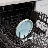 Bumkins Silicone Plate + Spoon Set: Disney Mickey Mouse sits in the top rack of an open dishwasher.