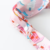 Close-up of the strap of Bumkins Packable Tote Bag: Boots on a white background, highlighting the snap closure.