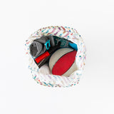 Top view of an open Bumkins Packable Tote Bag: Mickey & Friends Varsity on a white background with a basketball, sunglasses, and rolled-up towel inside.