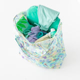 Bumkins Packable Tote Bag: Aloha Stitch sits open on a white background, with swim gear inside.