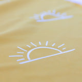 Close-up of the sun pattern on a Bumkins Reversible Roll & Go Blanket, Desert Boho, highlighting the soft fabric.