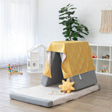 A play area features gray cushions with Bumkins Reversible Roll & Go Blanket, Desert Boho draped over the top, with a plush sun in front.