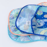 Close-up of Bumkins SuperBib® 3 Pack: Stitch Star-ring Up Trouble stacked on a white background, with focus on the exterior pocket.