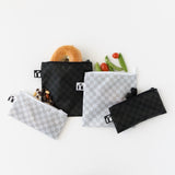 Roamio by Bumkins Snack Bag 4 Pack: Rich & Boujee, filled with snacks, is casually arranged on a white background.