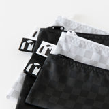 Close-up of Roamio by Bumkins Snack Bag 4 Pack: Rich & Boujee stacked on a white background, with focus on the zippers and logo labels.