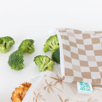 Bumkins Reusable Snack Bag, Large 2 Pack: Palm Check, with waterproof fabric, displayed with broccoli florets on a white background.