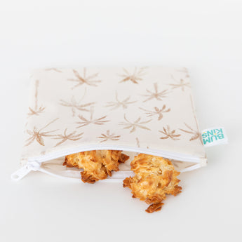 A Bumkins Reusable Snack Bag, Large 2 Pack: Palm Check, partially open to reveal cookies on a white background.