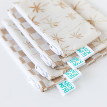 Close-up of Bumkins Reusable Snack Bag, Large 2 Pack: Palm Check, displayed stacked underneath similar bags on a white background.