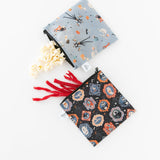Bumkins Reusable Snack Bag, Large 2 Pack: Everyday Is Halloween sits on a white background; one holds popcorn, the other red licorice.