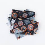 Bumkins Reusable Snack Bag, Large 2 Pack: Everyday Is Halloween lays underneath other bags with matching patterns on a white background.