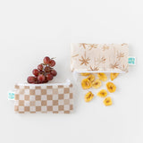 Bumkins Reusable Snack Bag, Small 2 Pack: Palm Check holds grapes and banana chips on a white background.