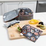 A Bumkins Reusable Snack Bag, Small 2 Pack: Everyday Is Halloween sits on a cutting board on a kitchen counter with food next to a lunch bag.