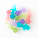 Bumkins Silicone Chewtensils®: Blue Jelly are scattered among other similar utensils on a white background.